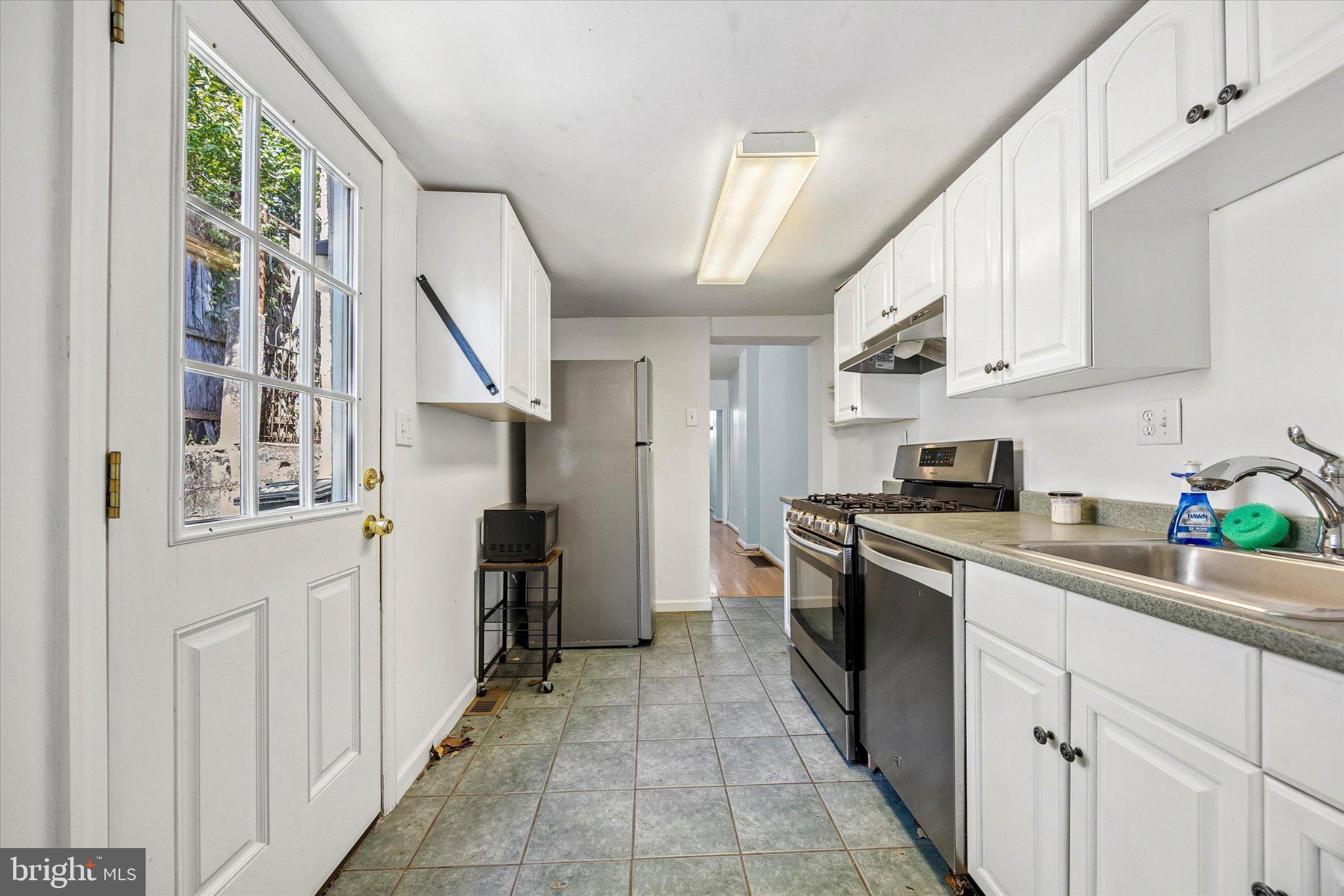 4334 Fleming Street Philadelphia, PA 19128 - Photo 10 of 25 a kitchen with stainless steel appliances granite countertop a refrigerator and a stove