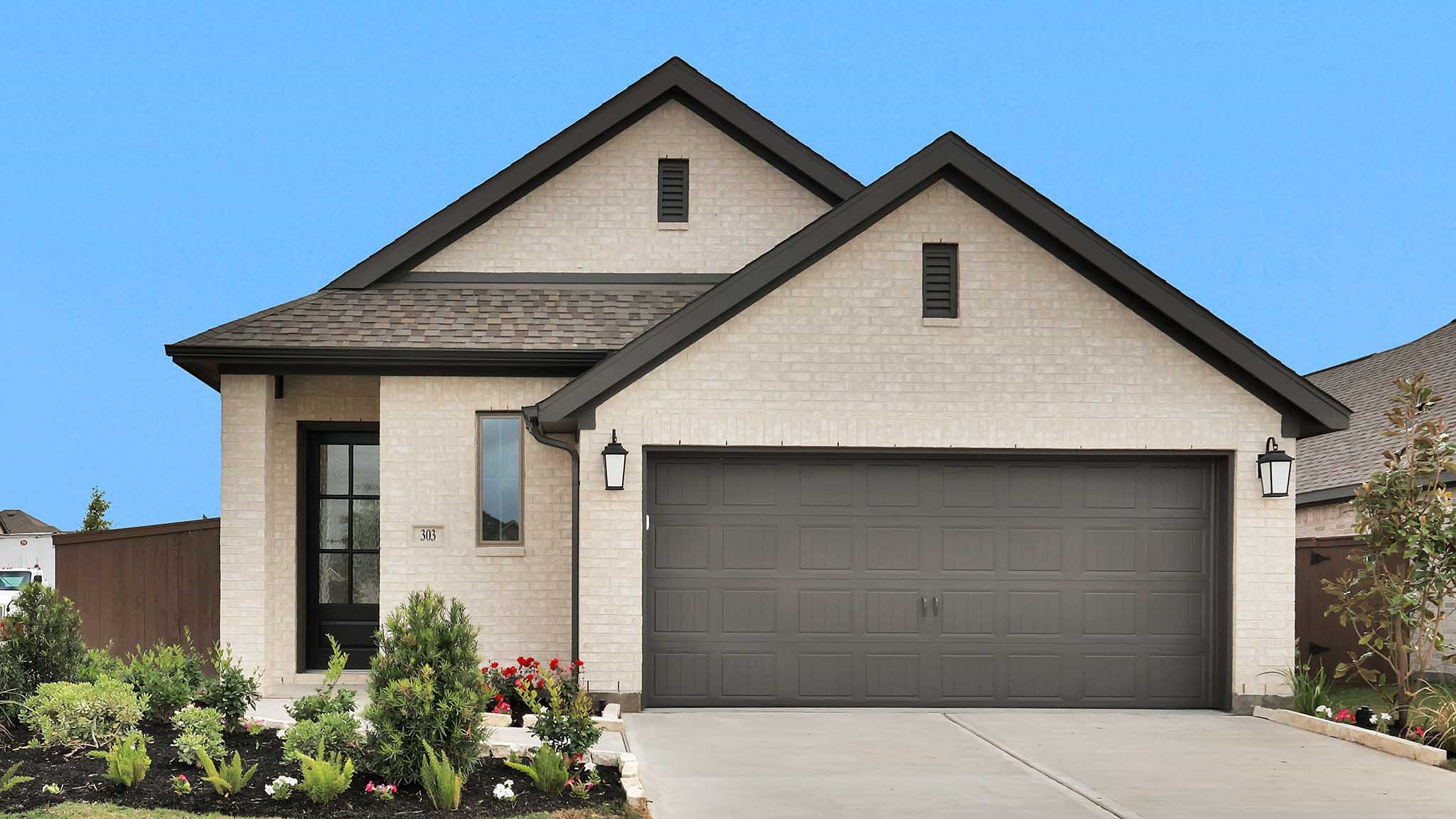 a front view of a house with plants