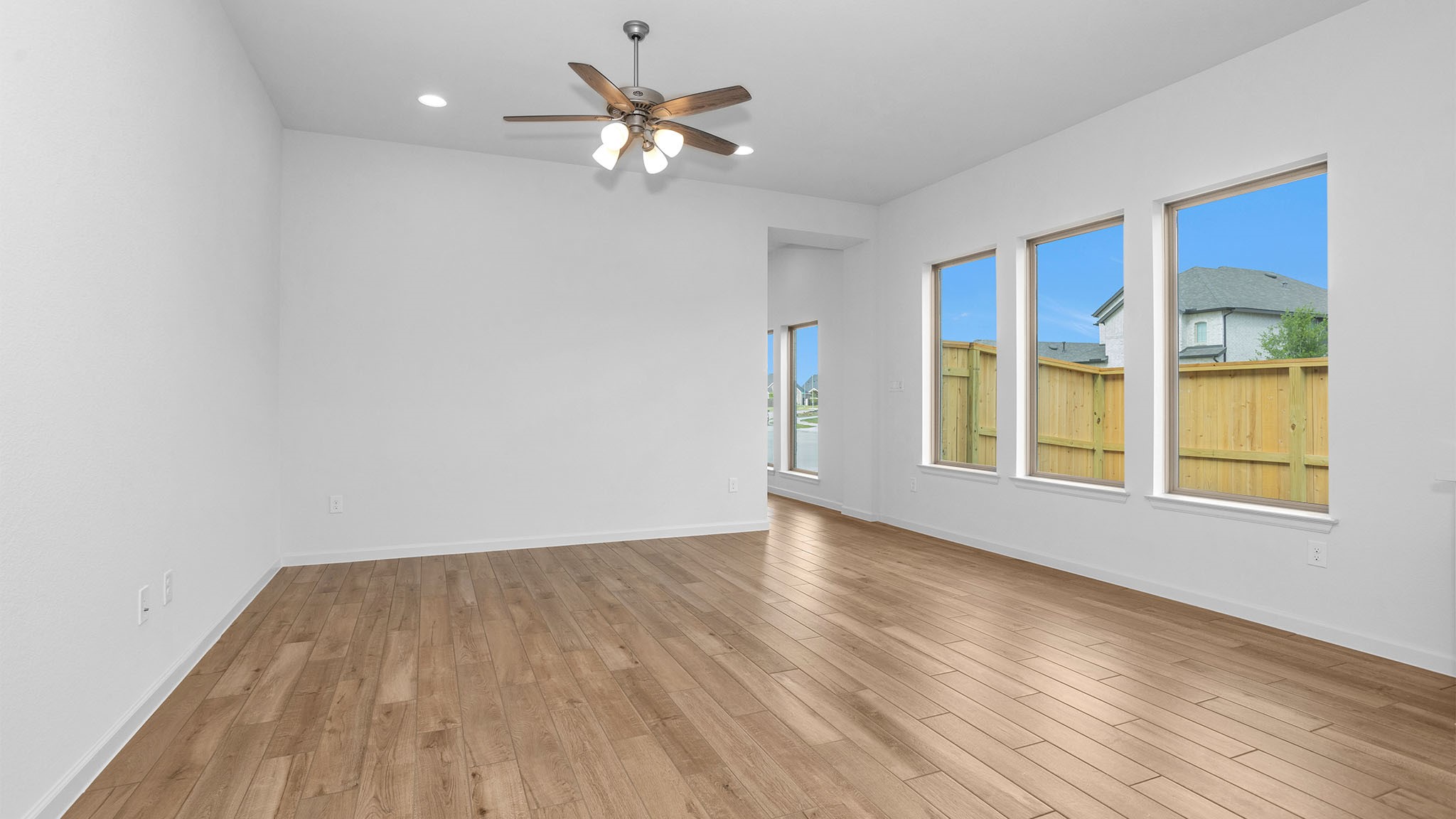 303 Eileen Drive Rosenberg, TX 77471 - Photo 9 of 20 a view of an empty room with a window and wooden floor