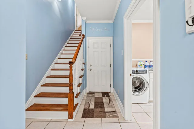 a view of entryway and hall with wooden floor