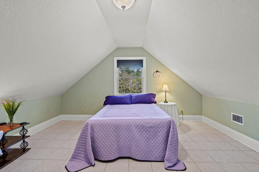 728 Otter Pond Road Westville, FL 32464 - Photo 18 of 39 a bedroom with a bed and a window