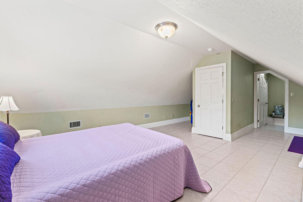 728 Otter Pond Road Westville, FL 32464 - Photo 19 of 39 a spacious bedroom with a bed and cabinets