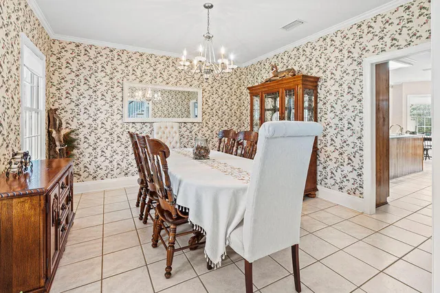 a dining room with furniture and chandelier kitchen view