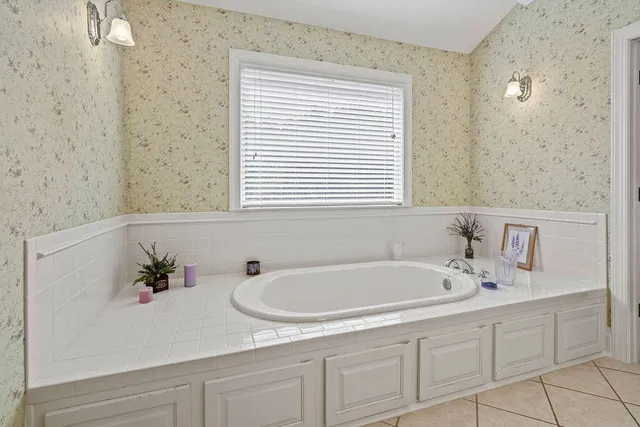 a white bath tub sitting next to a white sink