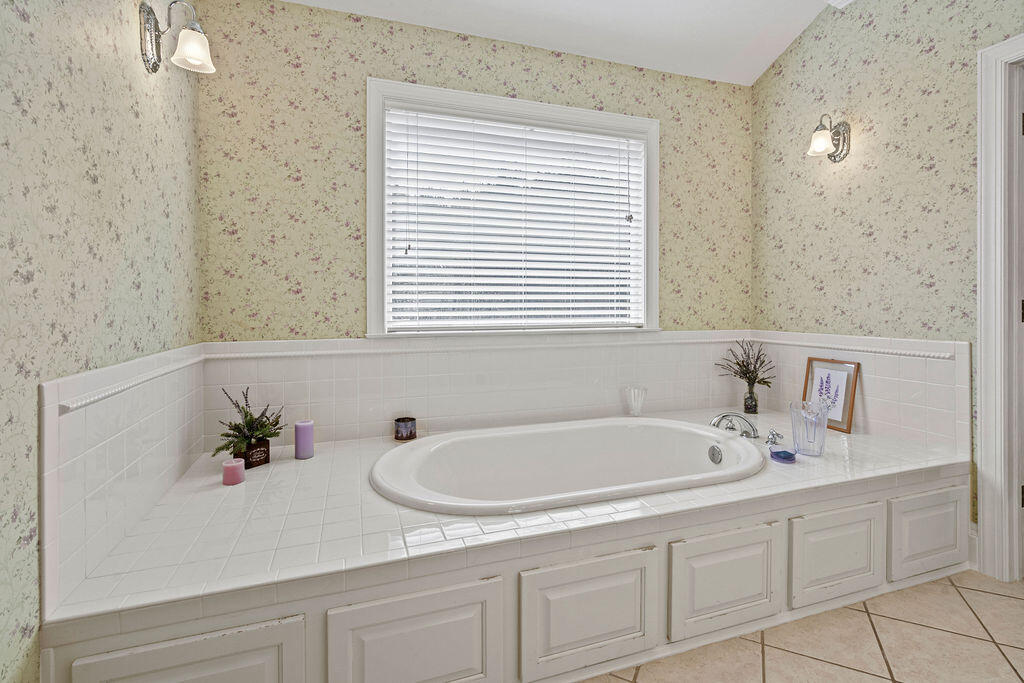 728 Otter Pond Road Westville, FL 32464 - Photo 22 of 39 a white bath tub sitting next to a white sink