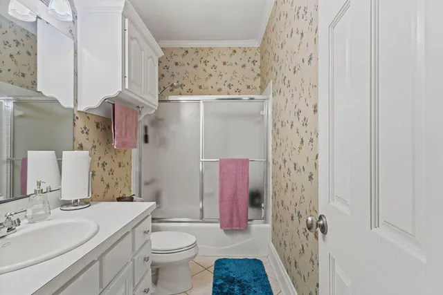 a bathroom with a sink toilet vanity and shower