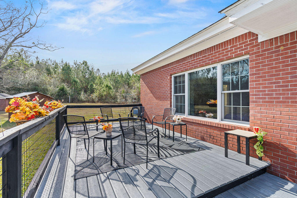 728 Otter Pond Road Westville, FL 32464 - Photo 29 of 39 a view of chairs and table on the deck