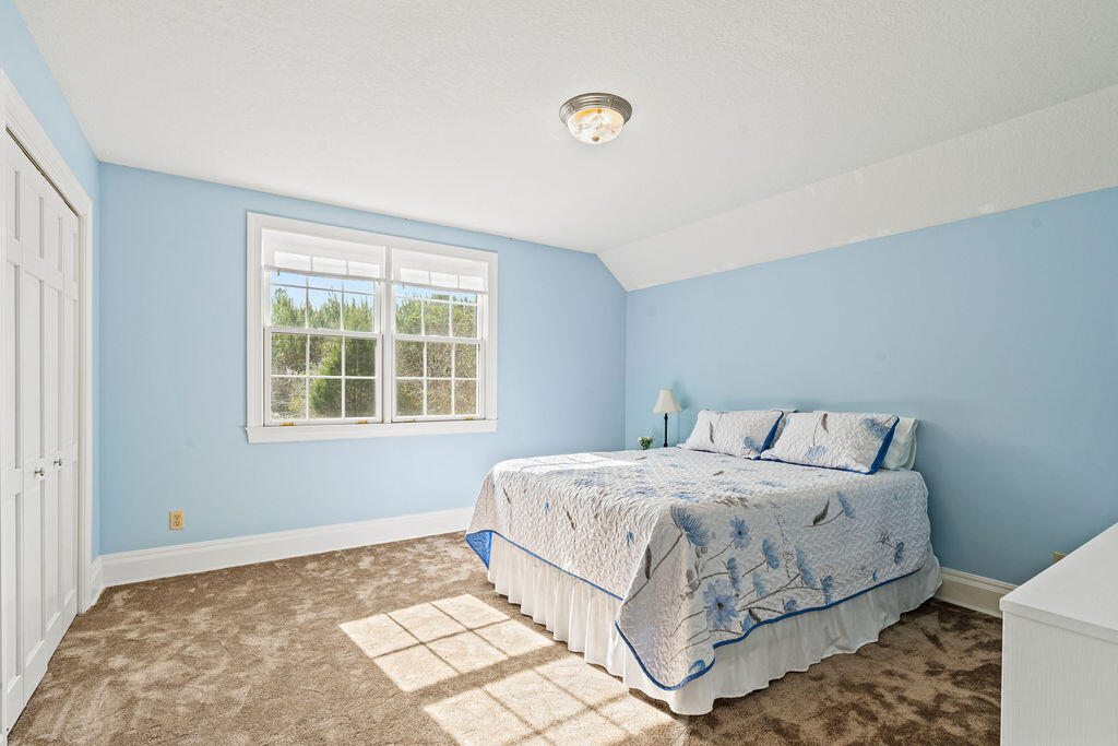 728 Otter Pond Road Westville, FL 32464 - Photo 30 of 39 a bedroom with a bed and a window