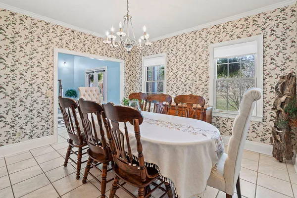 a view of a dining room with furniture and chandelier