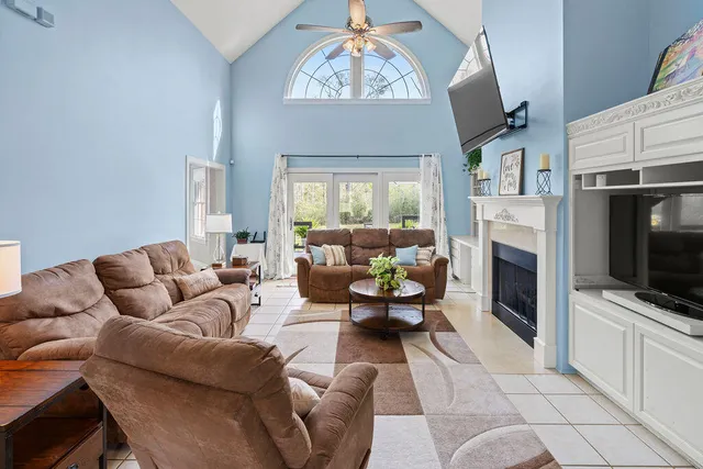 a living room with furniture a fireplace and a flat screen tv
