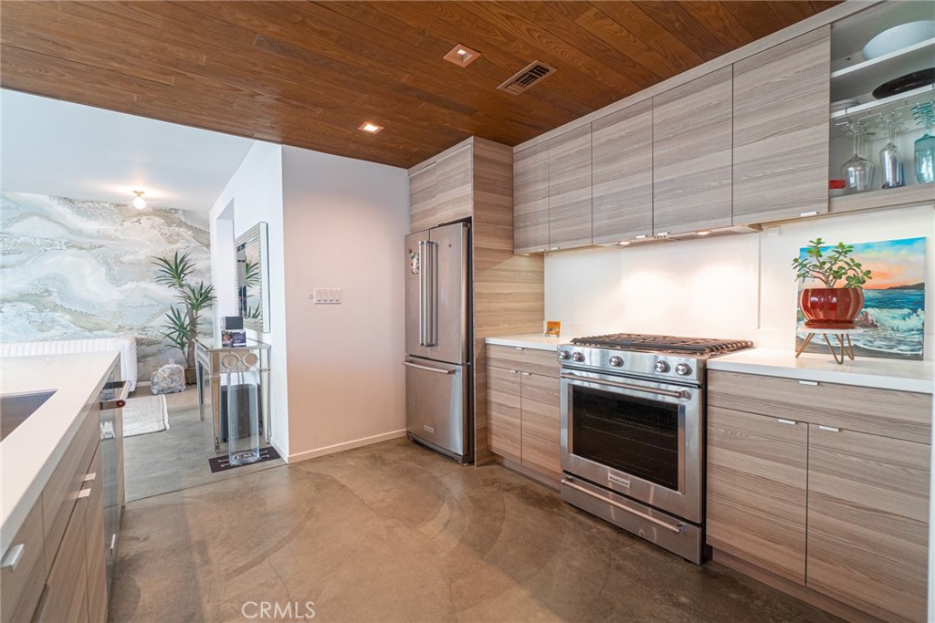 938 Palms Boulevard, Unit 2 Venice, CA 90291 - Photo 11 of 46 a kitchen with stainless steel appliances kitchen island granite countertop a stove and a sink