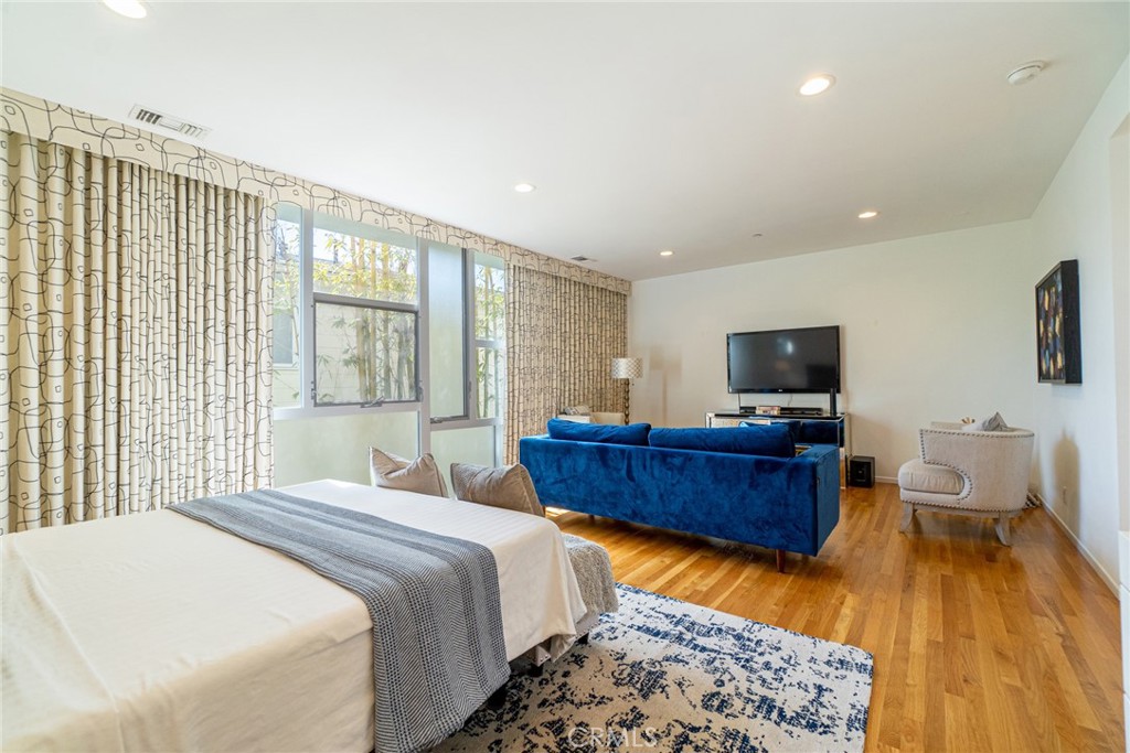 938 Palms Boulevard, Unit 2 Venice, CA 90291 - Photo 28 of 46 a bedroom with furniture and a flat screen tv