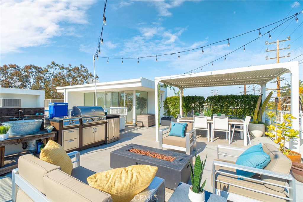 938 Palms Boulevard, Unit 2 Venice, CA 90291 - Photo 39 of 46 a living room with furniture a fireplace and a floor to ceiling window