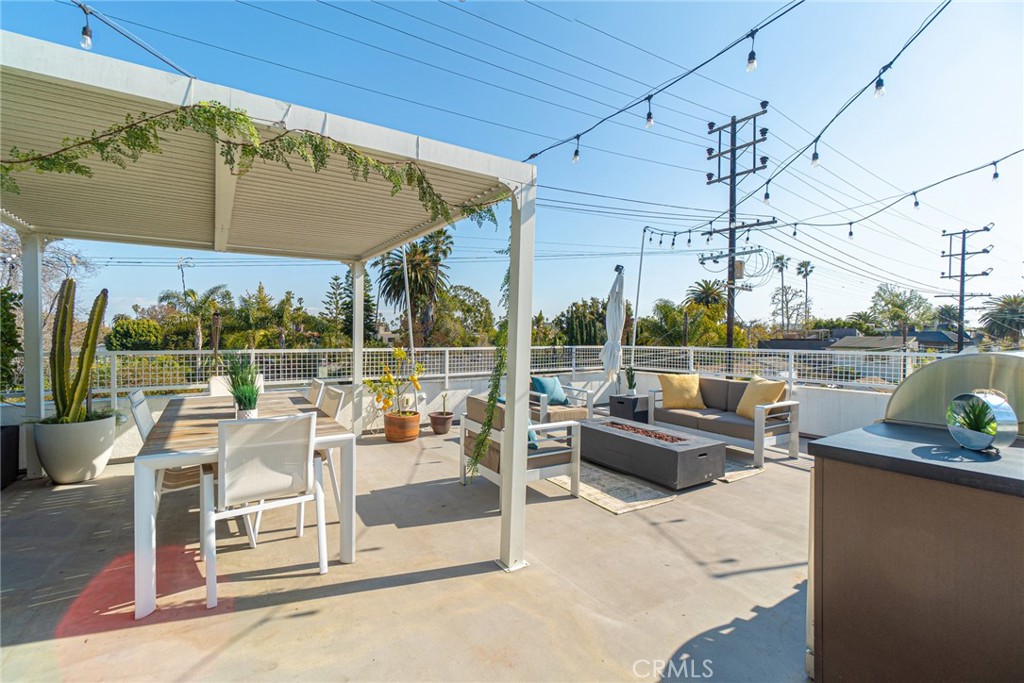 938 Palms Boulevard, Unit 2 Venice, CA 90291 - Photo 40 of 46 a view of a patio with couches chairs and potted plants