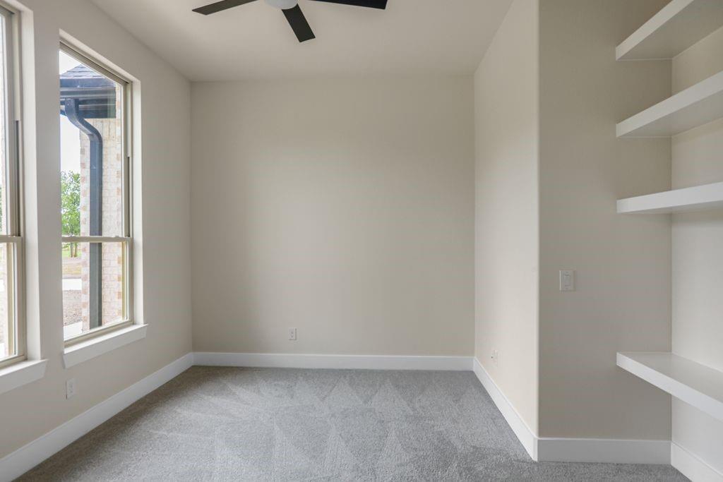 7637 County Road 1052 Celeste, TX 75423 - Photo 15 of 40 Spare room featuring ceiling fan and carpet