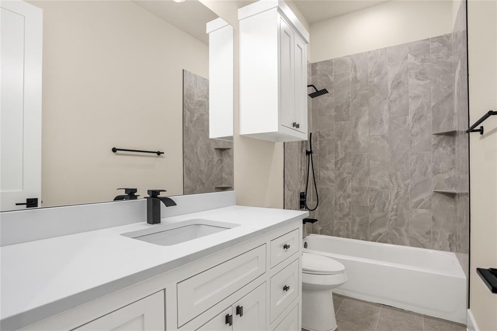 7637 County Road 1052 Celeste, TX 75423 - Photo 27 of 40 Bathroom featuring vanity, shower / bath combination, and tile patterned flooring