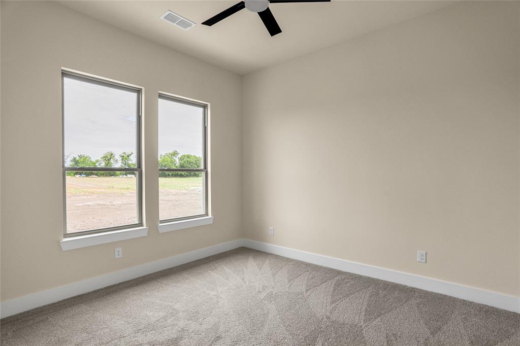7637 County Road 1052 Celeste, TX 75423 - Photo 31 of 40 Unfurnished room featuring carpet floors and a ceiling fan