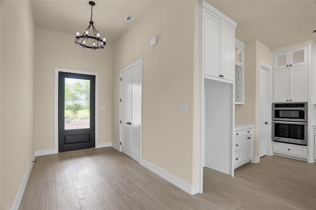 7637 County Road 1052 Celeste, TX 75423 - Photo 6 of 40 Entryway featuring a chandelier and light wood-style flooring