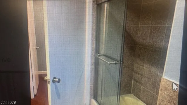 a bathroom with a glass shower door