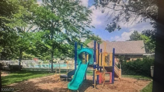 a view of a park with iron fence