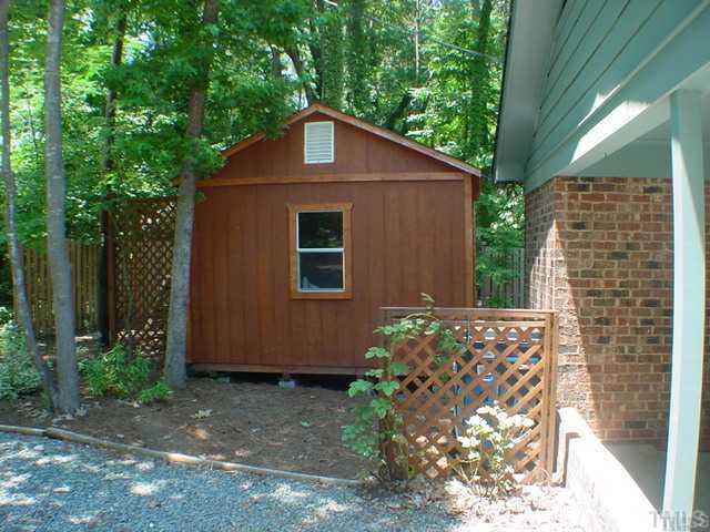 4404 Malvern Road Durham, NC 27707 - Photo 2 of 12 12 X 16 workshop with storage loft and bookcase dividers.....utility room to the right.....storage spot for the garbage can....path beside workshop to allow access to the back area. Workshop
