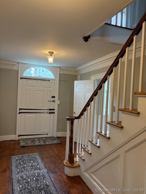 a view of entryway and hall with wooden floor