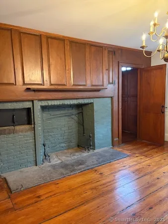 a view of room with wooden floor and staircase