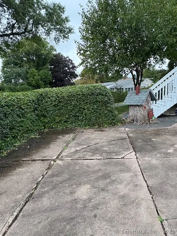 a backyard of a house with table and chairs