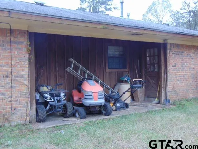 a wooden door in a backyard of a house