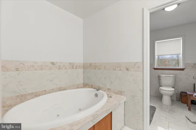 a bathroom with a bathtub and toilet