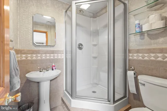 a bathroom with a sink mirror toilet and shower