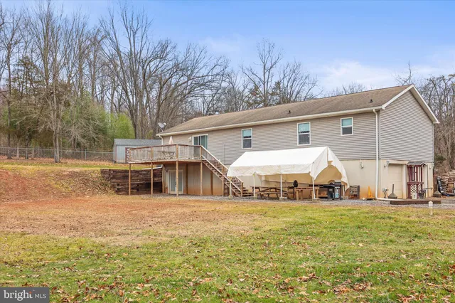a view of a white house with a yard