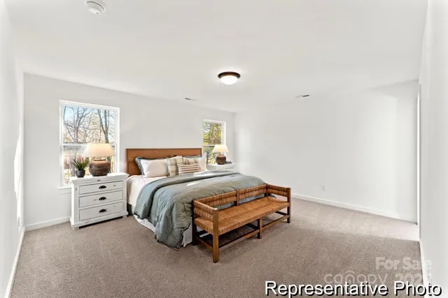 a spacious bedroom with a bed and a window