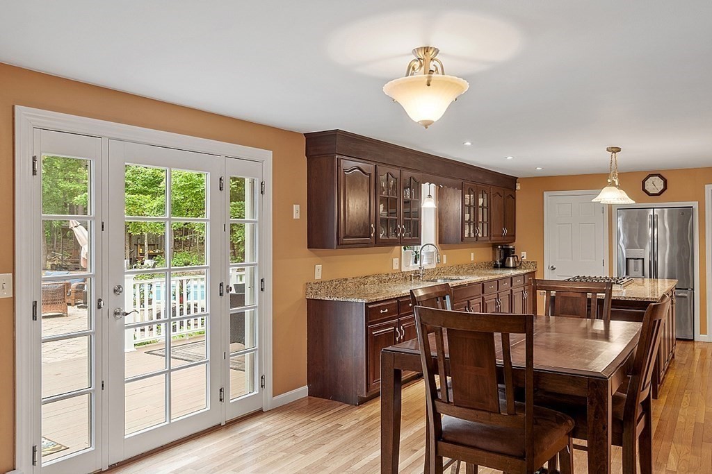 237 Hollis Road Lunenburg, MA 01462 - Photo 11 of 42 a view of a dining room with furniture a chandelier and wooden floor