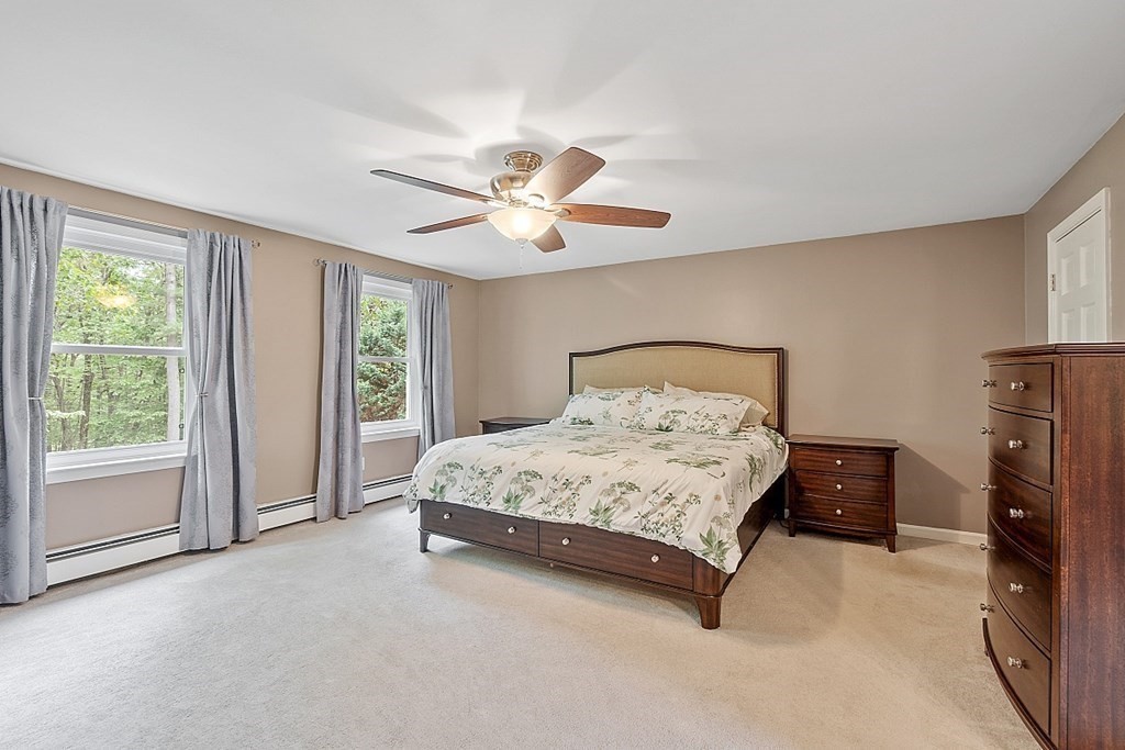 237 Hollis Road Lunenburg, MA 01462 - Photo 19 of 42 a spacious bedroom with a bed and a tv