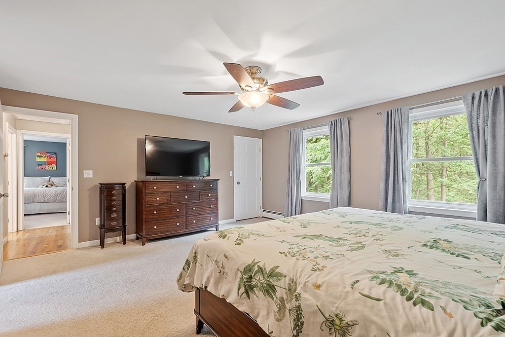 237 Hollis Road Lunenburg, MA 01462 - Photo 20 of 42 a bedroom with a bed and a flat screen tv