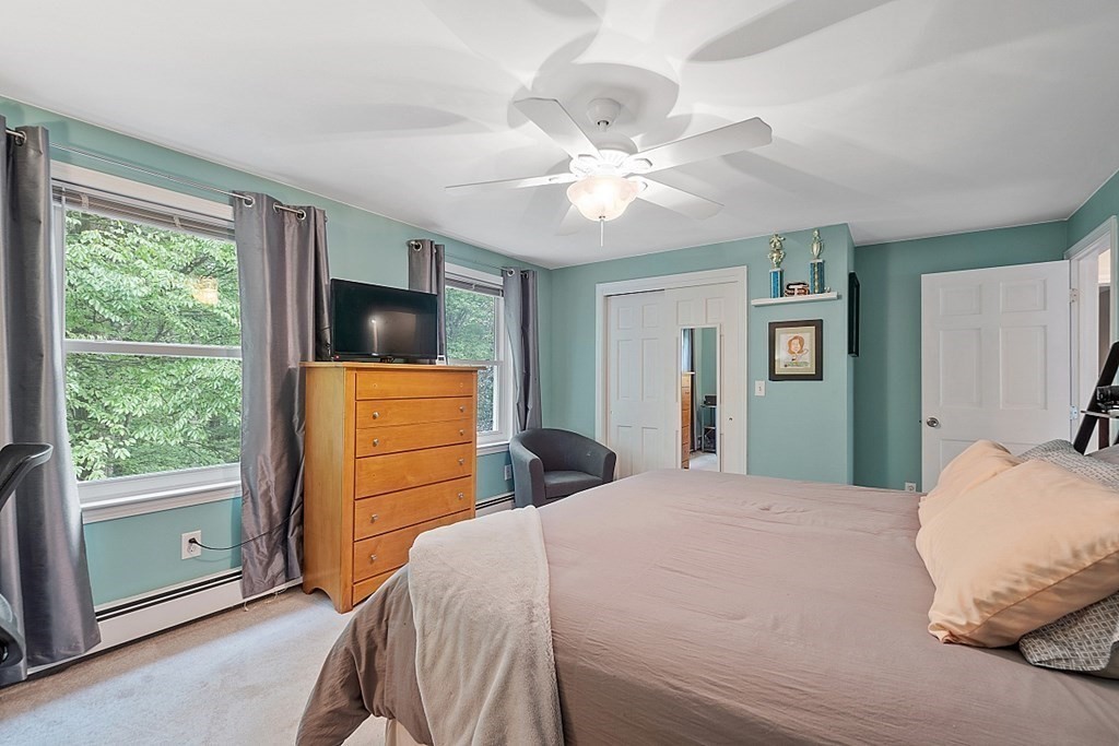 237 Hollis Road Lunenburg, MA 01462 - Photo 24 of 42 a bedroom with a bed and a flat screen tv