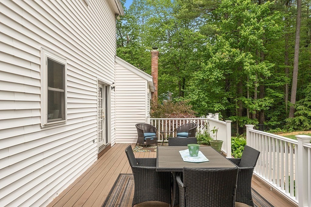 237 Hollis Road Lunenburg, MA 01462 - Photo 26 of 42 a deck with a table and chairs and wooden floor