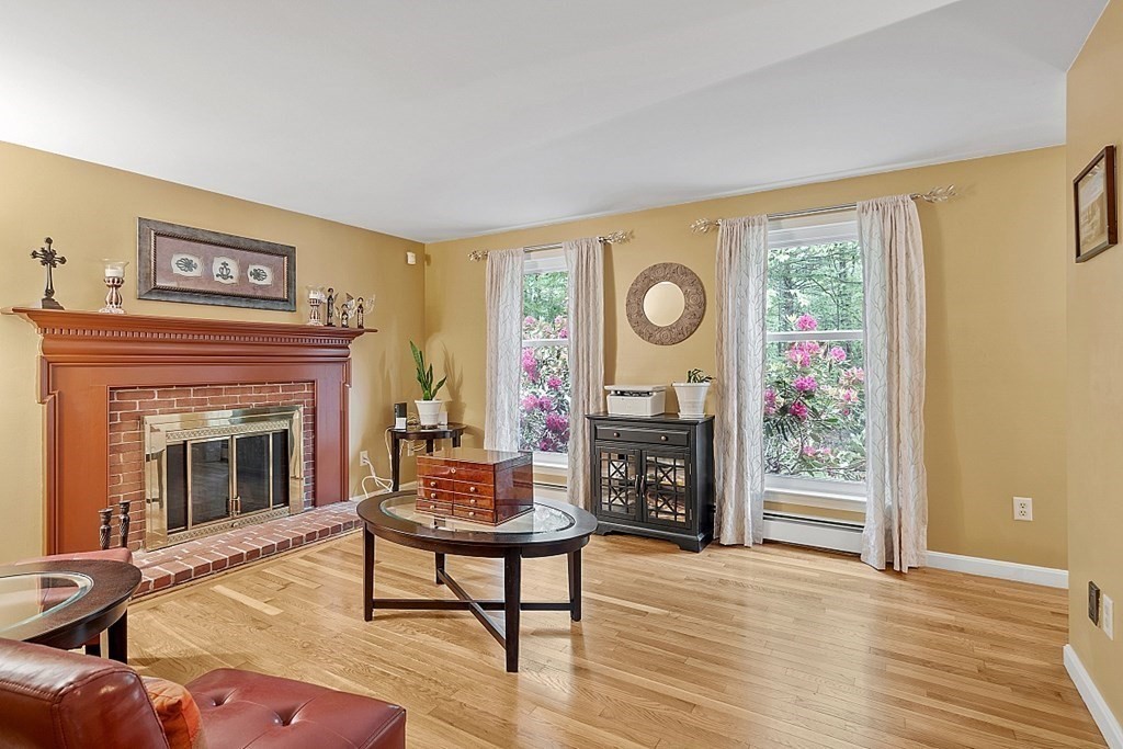 237 Hollis Road Lunenburg, MA 01462 - Photo 6 of 42 a living room with furniture and a fireplace