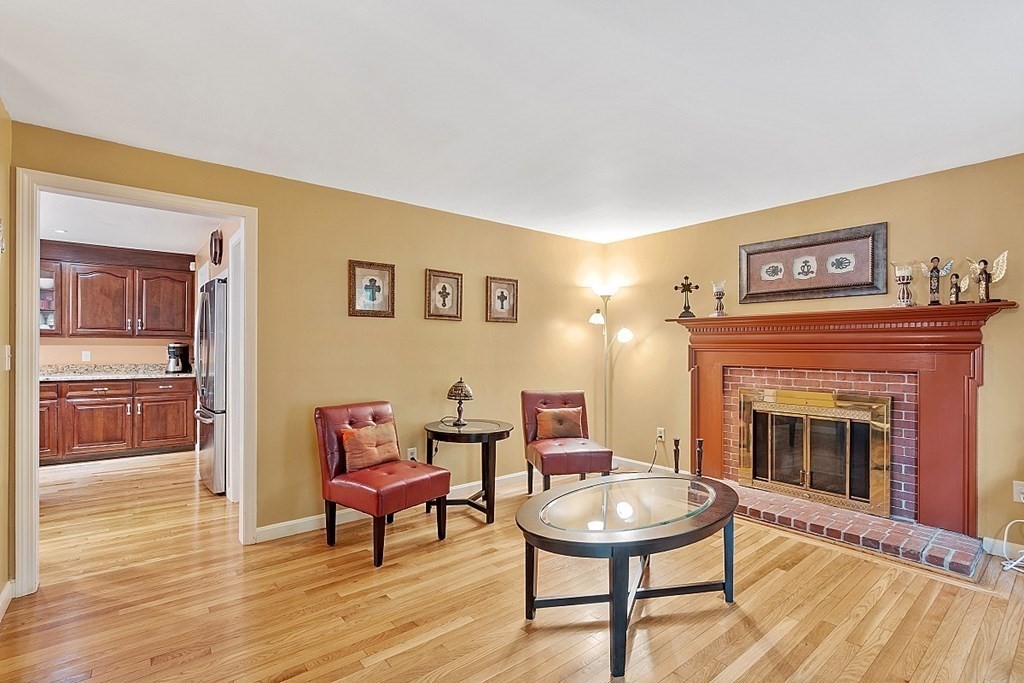 237 Hollis Road Lunenburg, MA 01462 - Photo 7 of 42 a living room with furniture and a fireplace