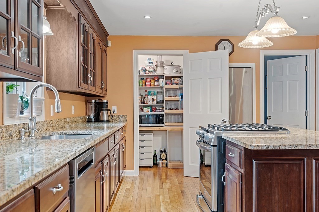 237 Hollis Road Lunenburg, MA 01462 - Photo 10 of 42 a kitchen with stainless steel appliances granite countertop a sink stove and cabinets