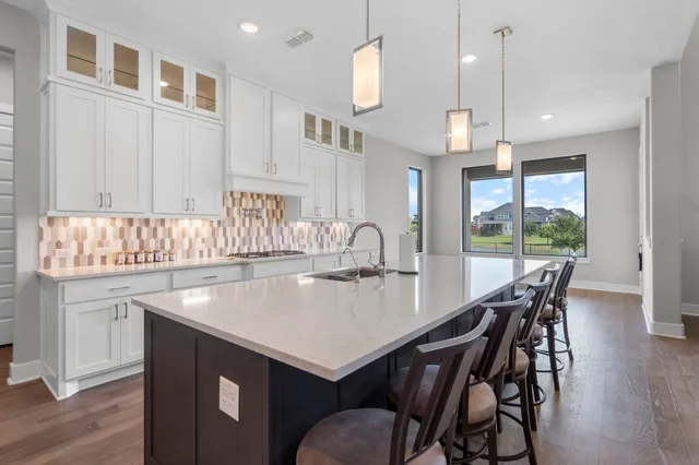 a kitchen with a table chairs and chandelier
