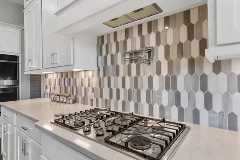 a kitchen with a stove and a refrigerator