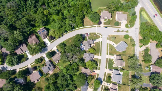 an aerial view of residential house with outdoor space and swimming pool