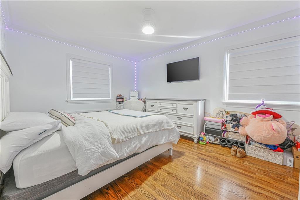 1237 82nd Street Brooklyn, NY 11228 - Photo 11 of 24 a bedroom with a bed and flat screen tv