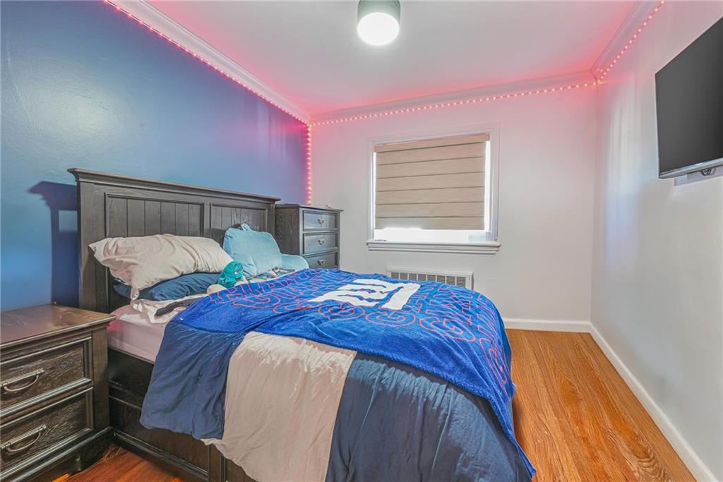 1237 82nd Street Brooklyn, NY 11228 - Photo 12 of 24 a bedroom with a bed and a flat screen tv