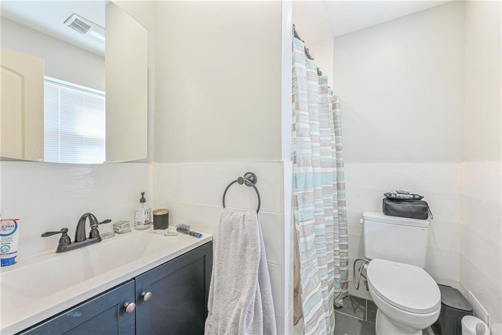 1237 82nd Street Brooklyn, NY 11228 - Photo 14 of 24 a bathroom with a sink toilet and shower