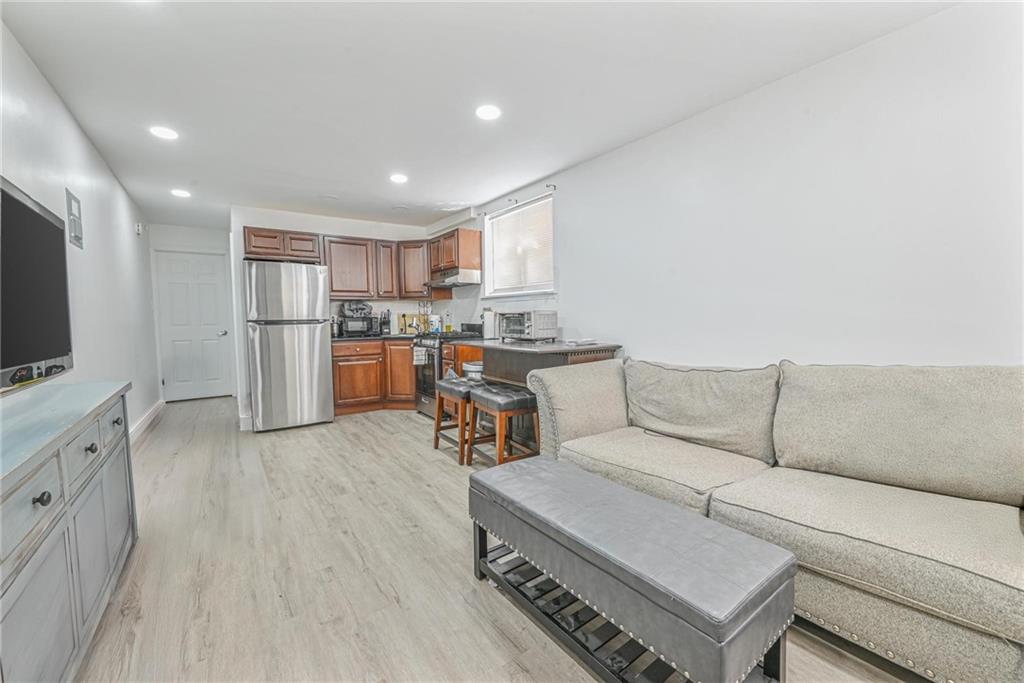 1237 82nd Street Brooklyn, NY 11228 - Photo 15 of 24 a living room with furniture and a flat screen tv