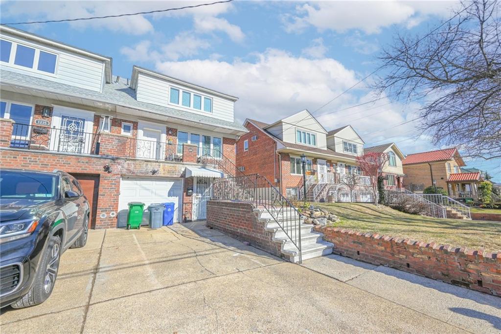 1237 82nd Street Brooklyn, NY 11228 - Photo 4 of 24 a view of multiple houses with a street