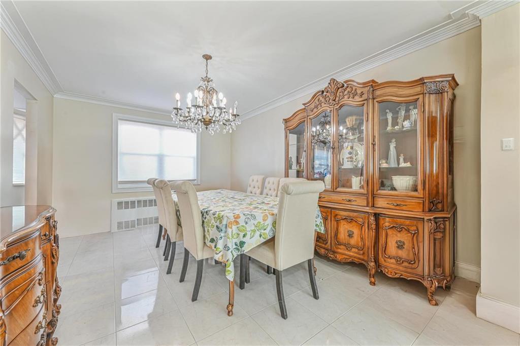 1237 82nd Street Brooklyn, NY 11228 - Photo 8 of 24 a view of a dining room with furniture and a chandelier